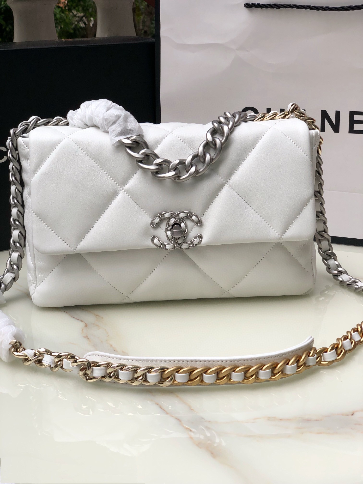 Ch*el 19 large handbag shiny leather, gold-tone, silver-tone & ruthenium-finish metal white 7.8 × 11.7 × 3.9 in
