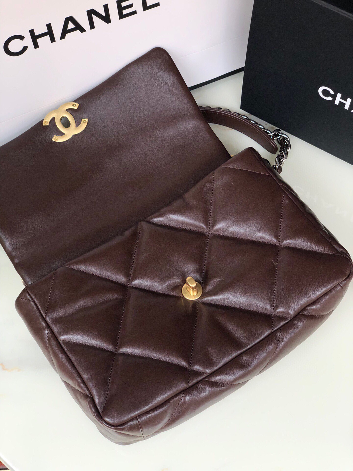 Ch*el 19 large handbag shiny leather, gold-tone, silver-tone & ruthenium-finish metal brown 7.8 × 11.7 × 3.9 in